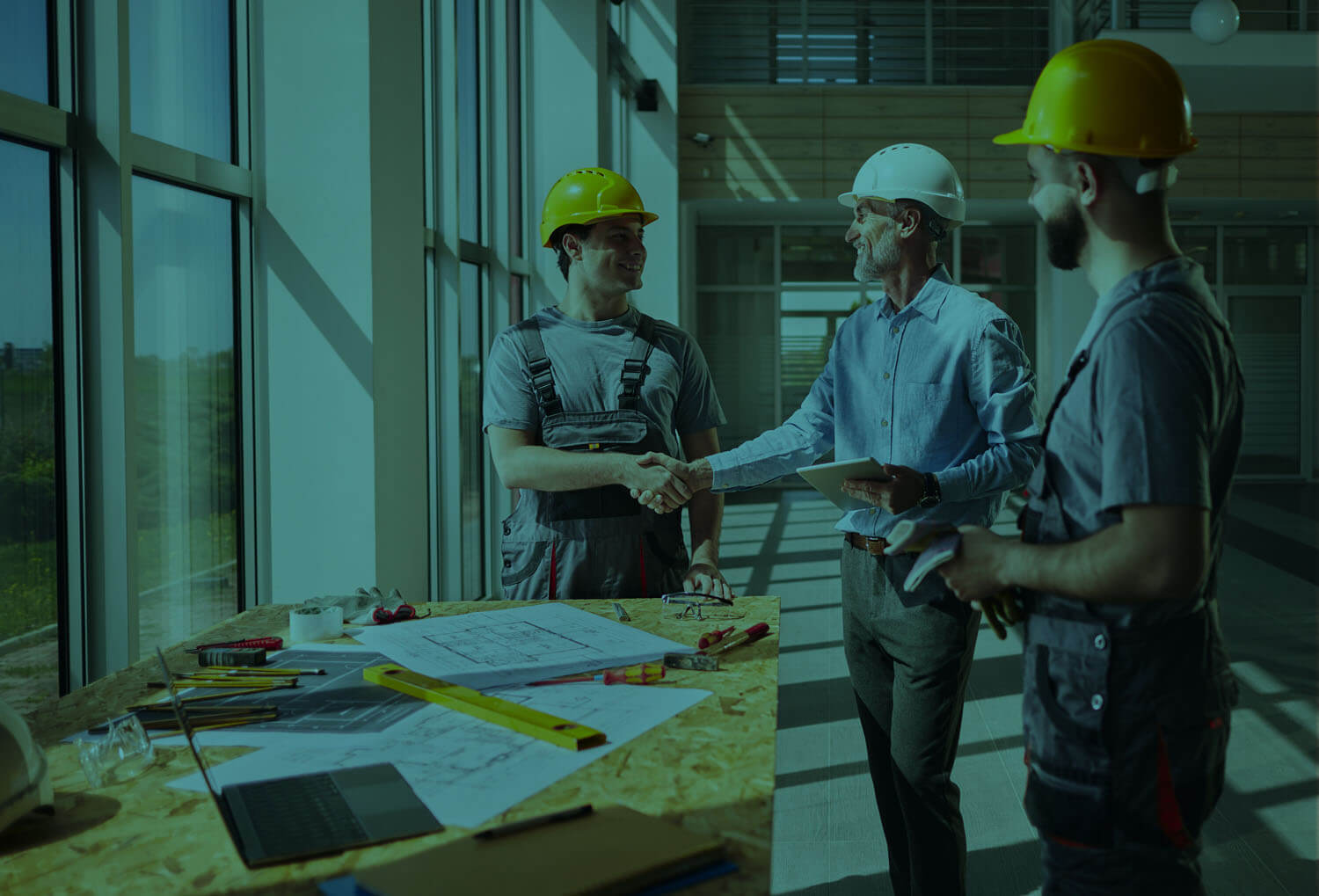 construction workers shaking hands on site